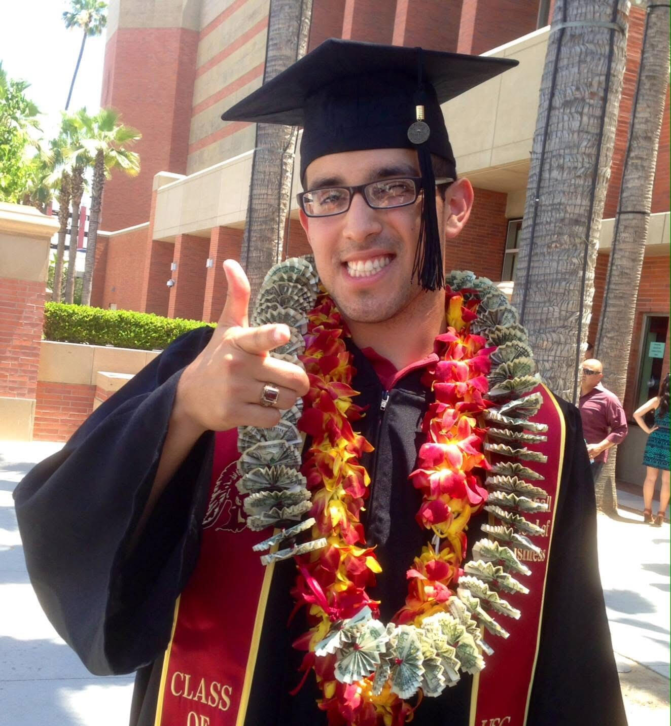 Graduation A photograph of the founder, Michael Cuellar, after he graduated from the University of Sothern California wearing his cap and gown.